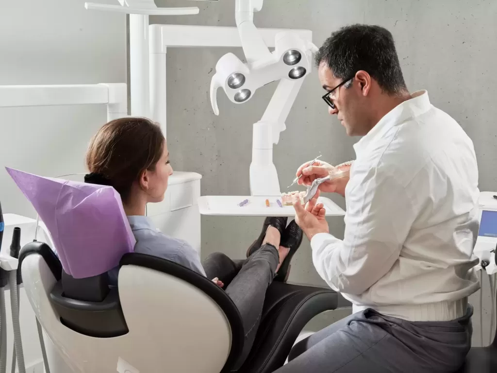 Dental professional consulting a patient about mini dental implants and dental implant procedure steps