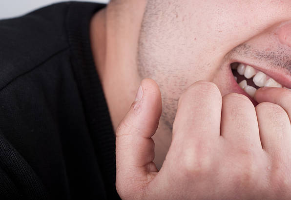 man biting nails